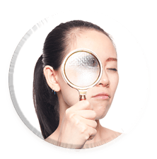 Woman with magnifying glass at her right eye