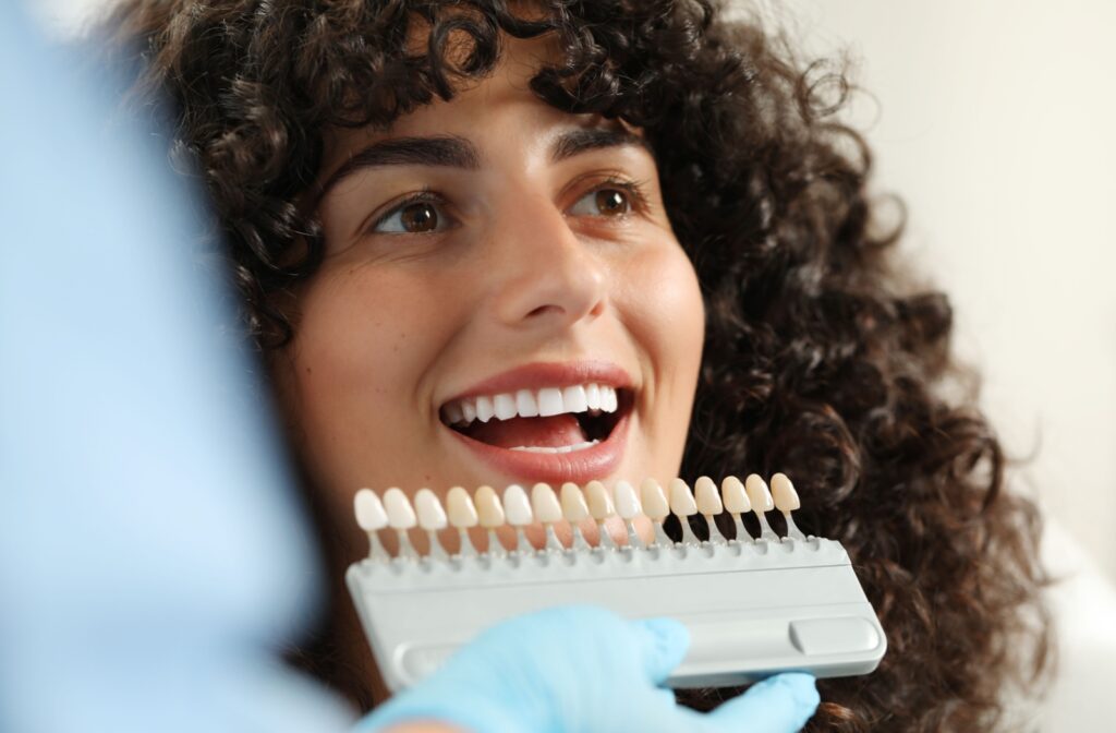 A person getting matched with the right shade for their veneers