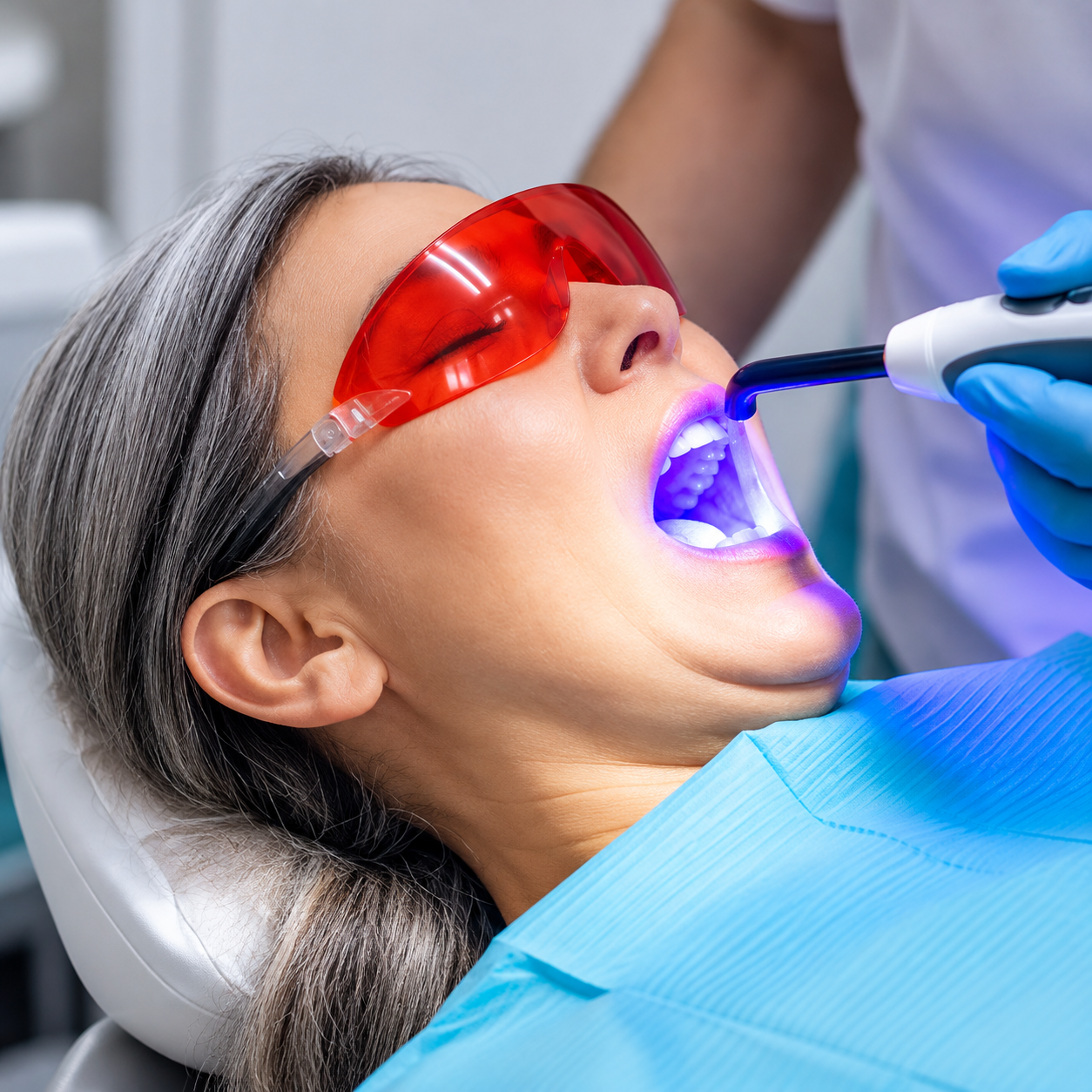 A dental professional discussing a tooth shade with a patient