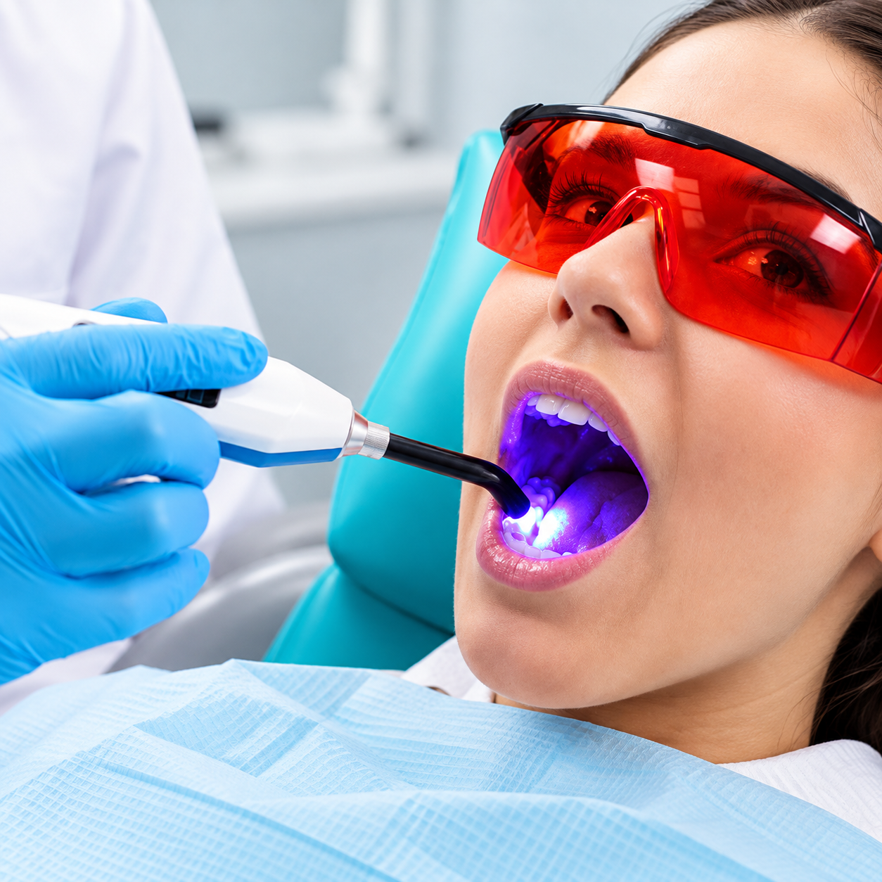 A smiling patient sharing a high five with a dental professional