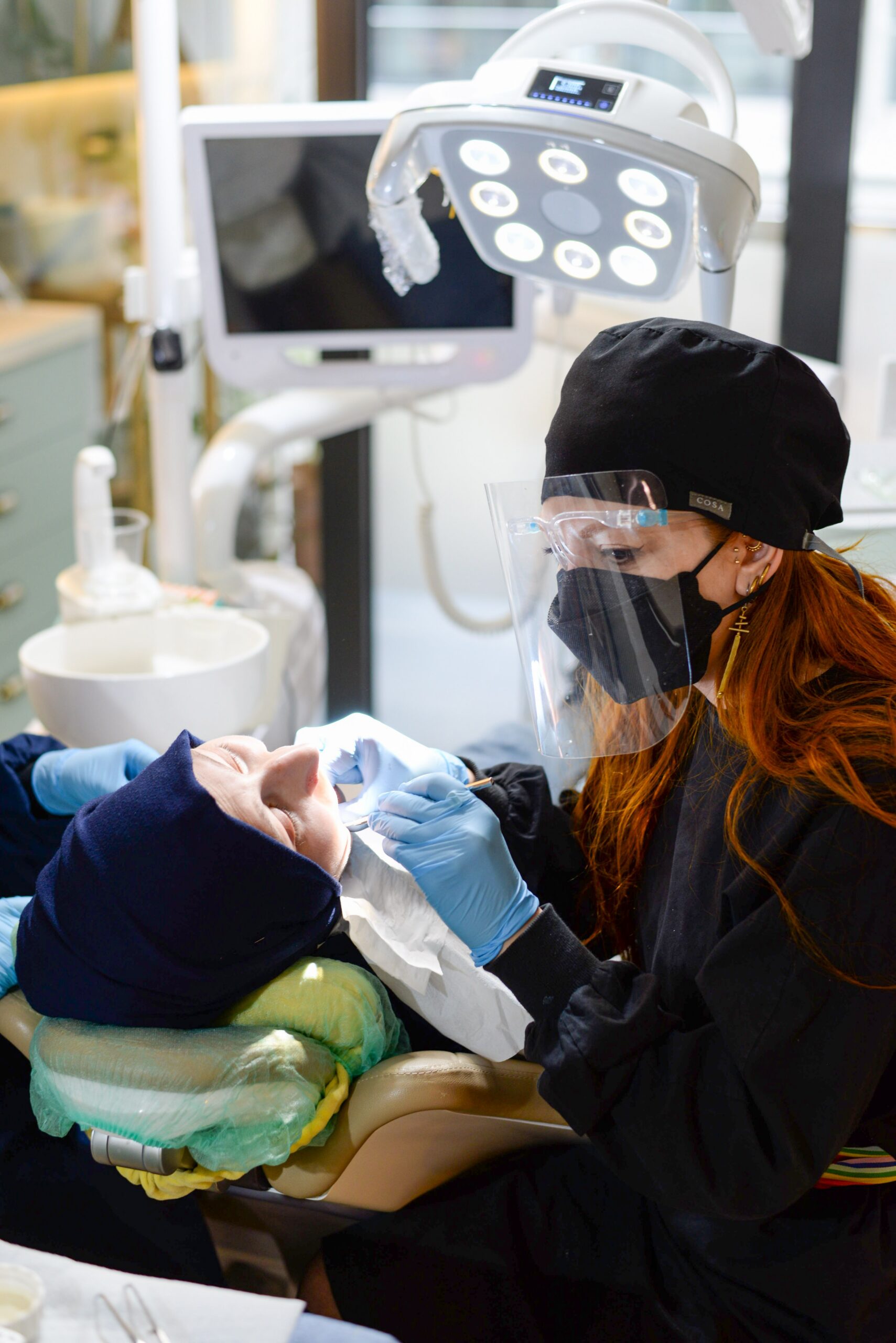 A dentist explaining an implant and crown to a patient