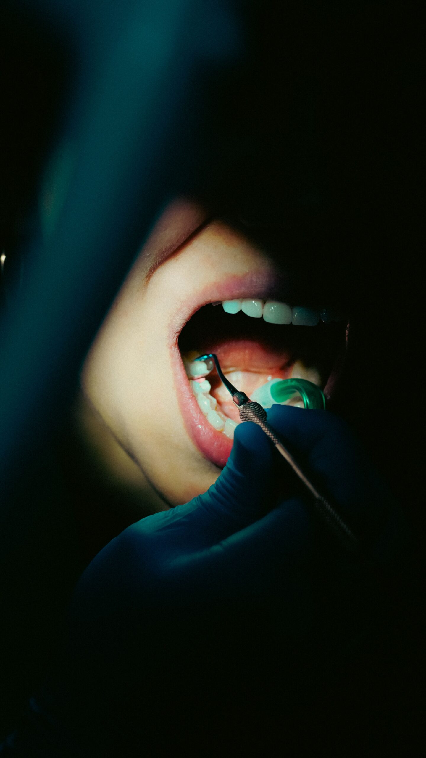 A smiling patient comparing tooth shades with a dental professional