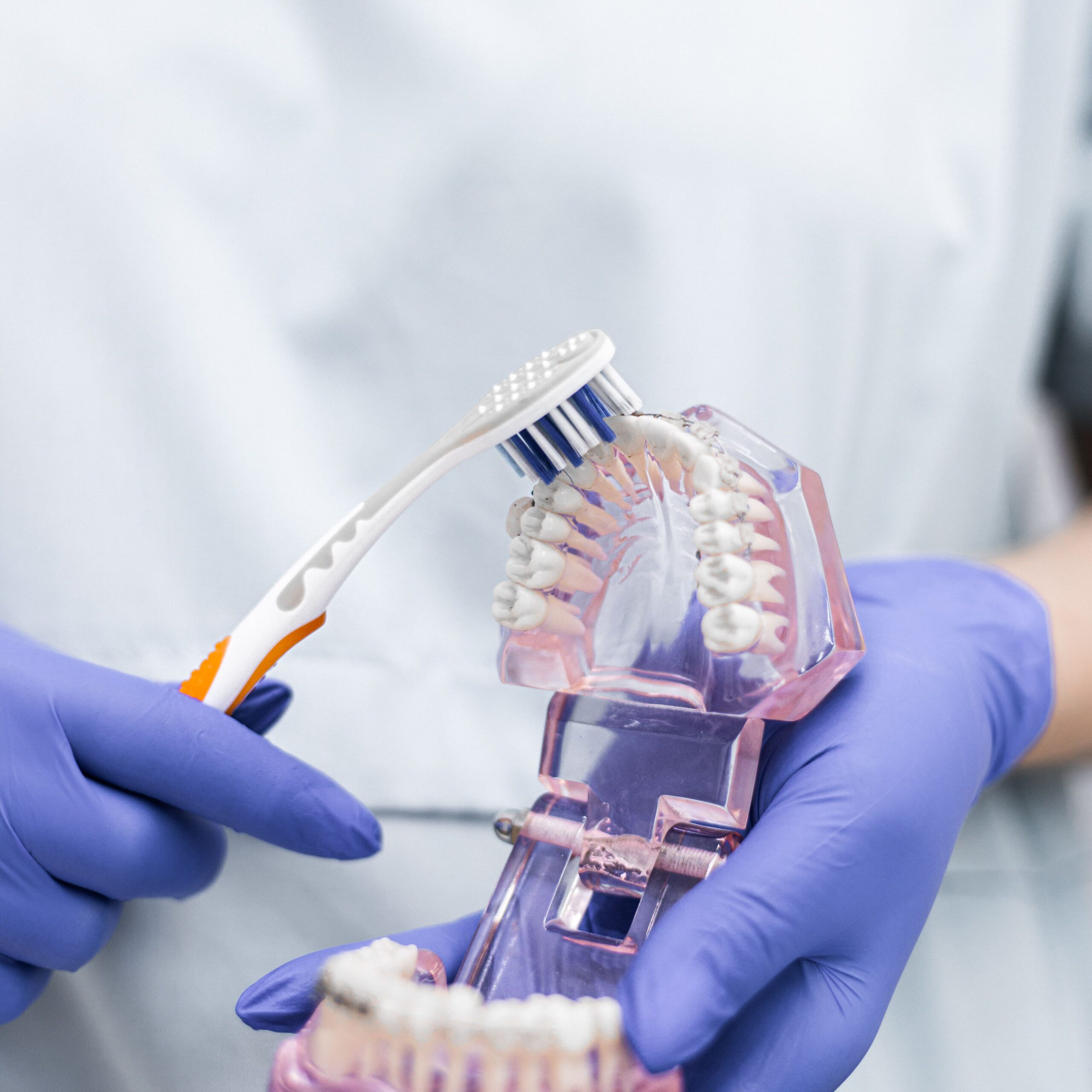 A smiling patient sharing a high five with a dental professional