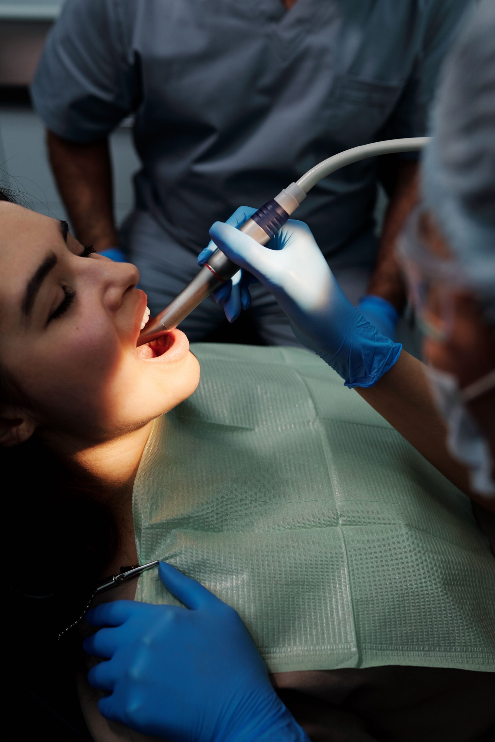 A dental professional discussing a tooth shade with a patient