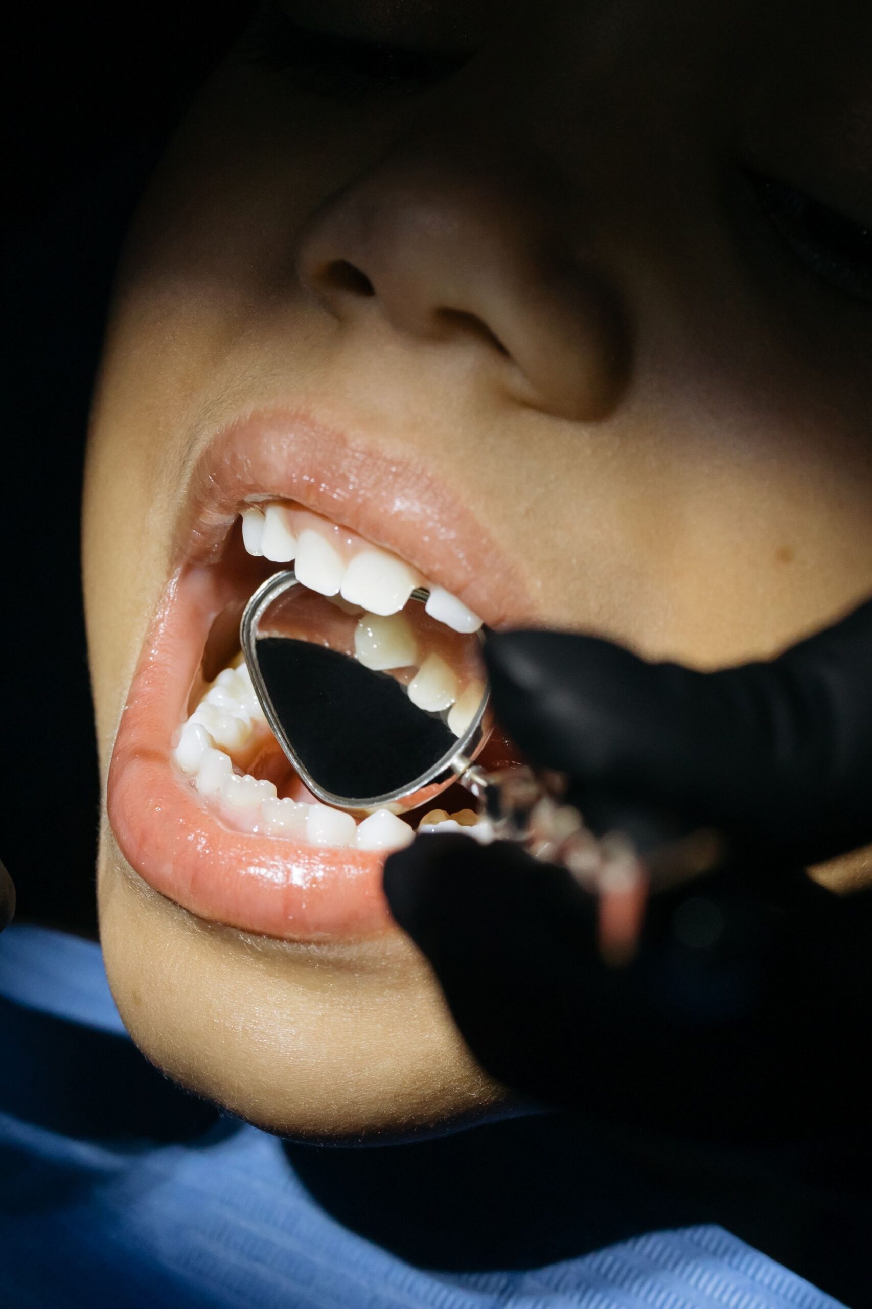 A dental professional discussing a tooth shade with a patient