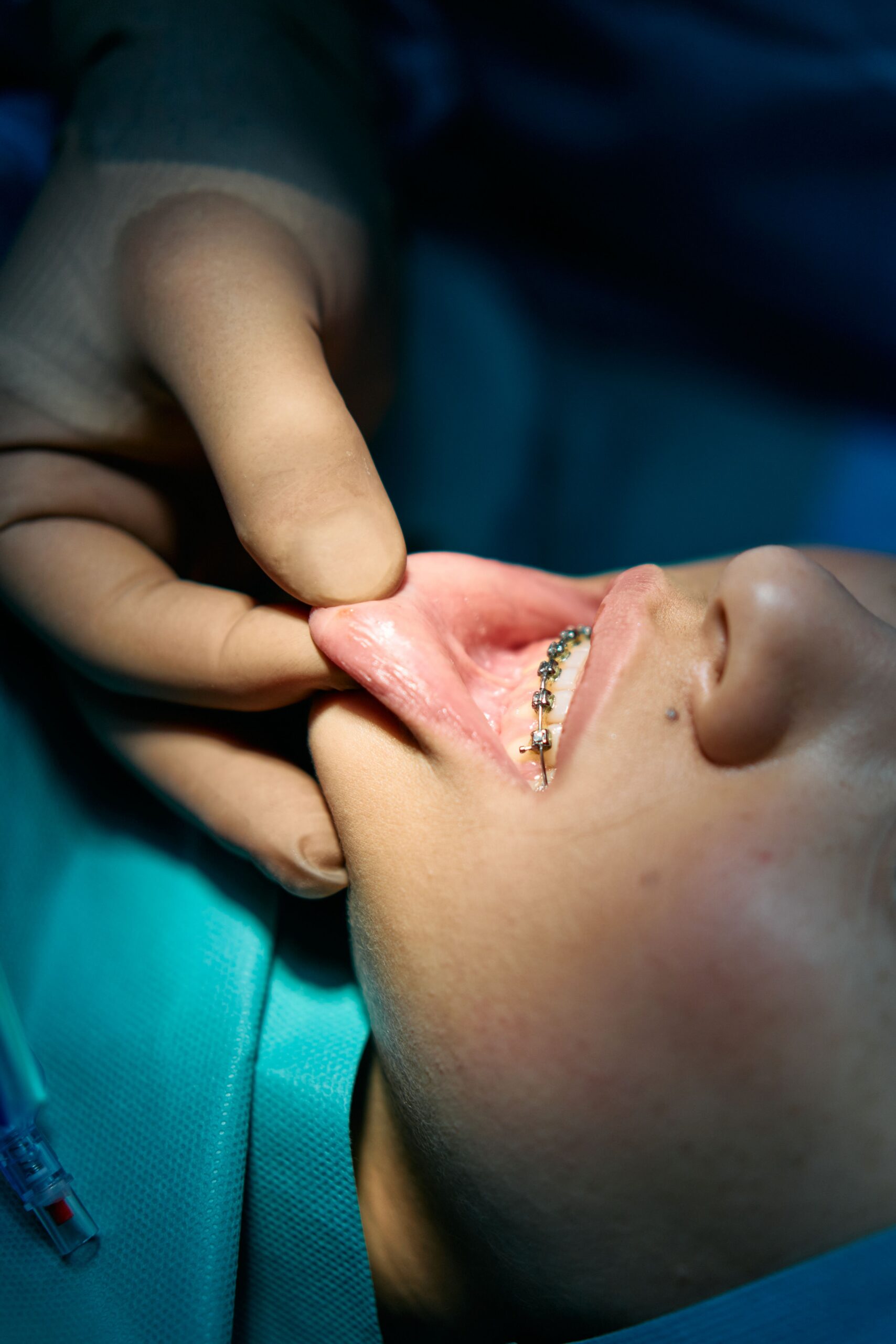 A smiling patient sharing a high five with a dental professional