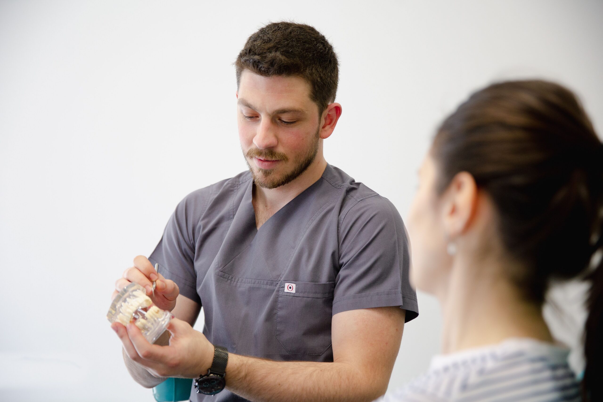 A smiling patient sharing a high five with a dental professional