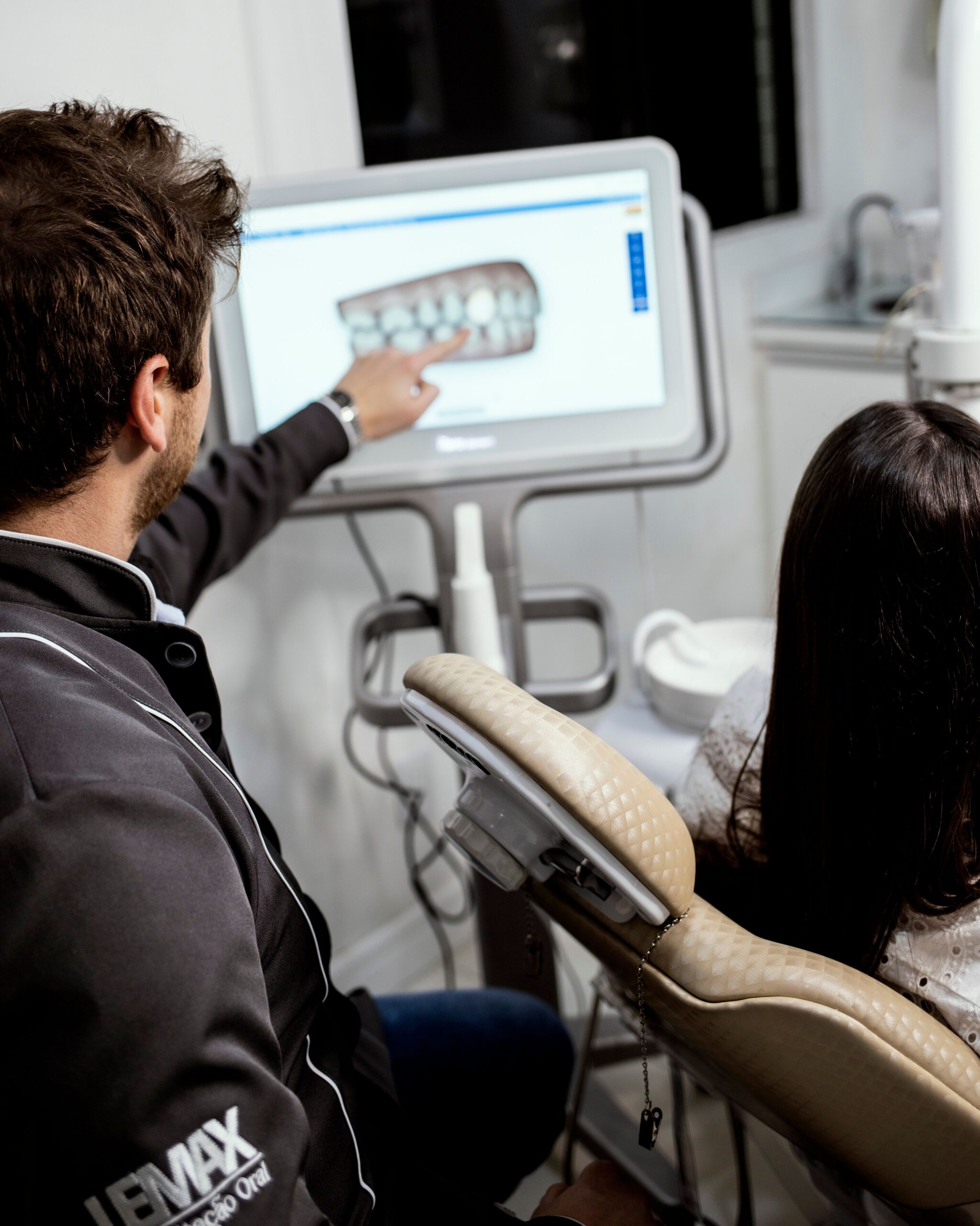 A dental professional discussing a tooth shade with a patient