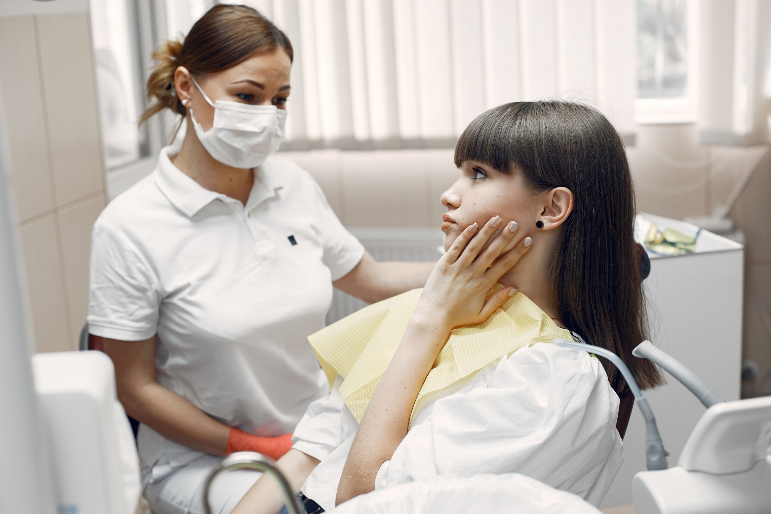 A dental professional discussing a tooth shade with a patient