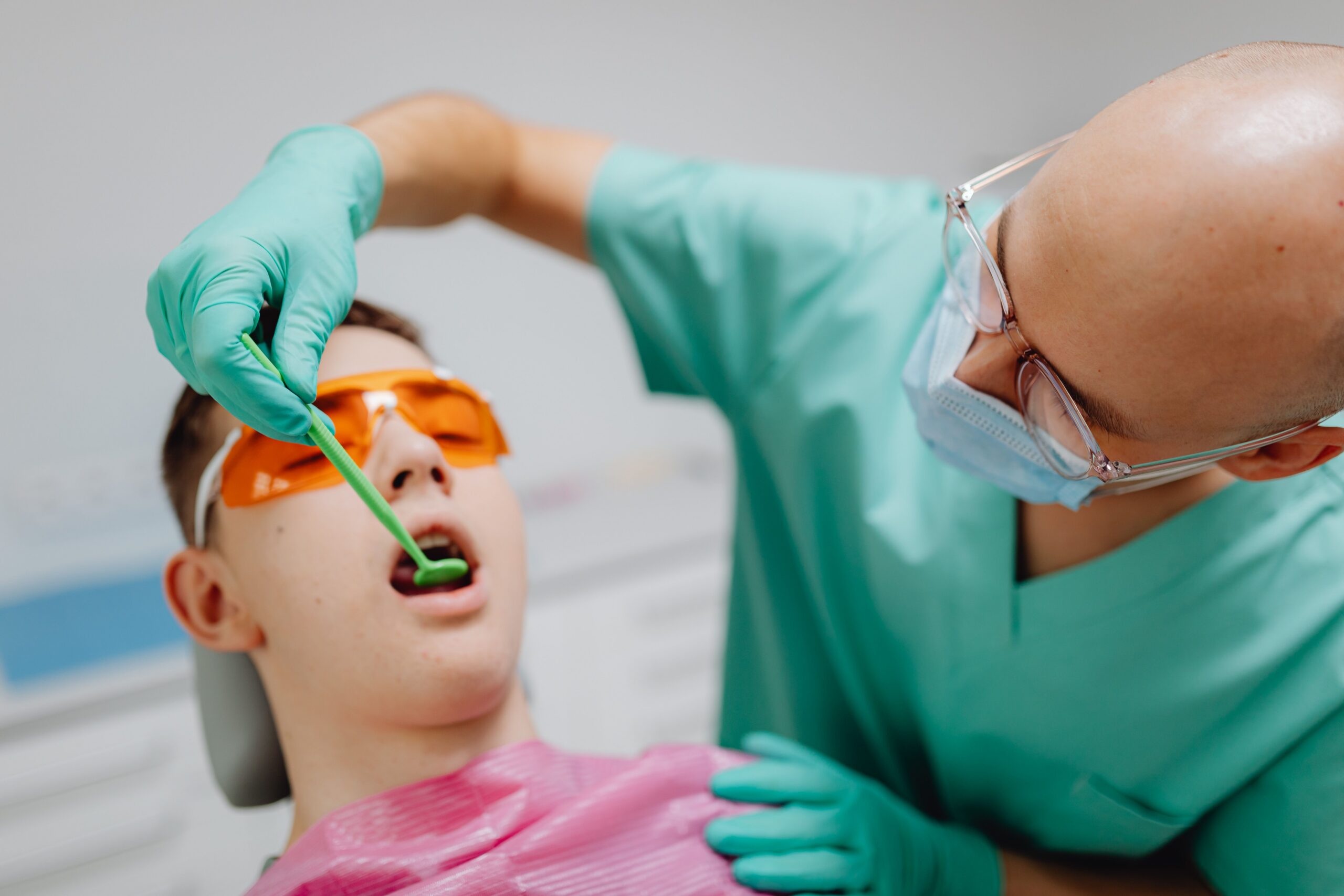 A dentist explaining an implant and crown to a patient