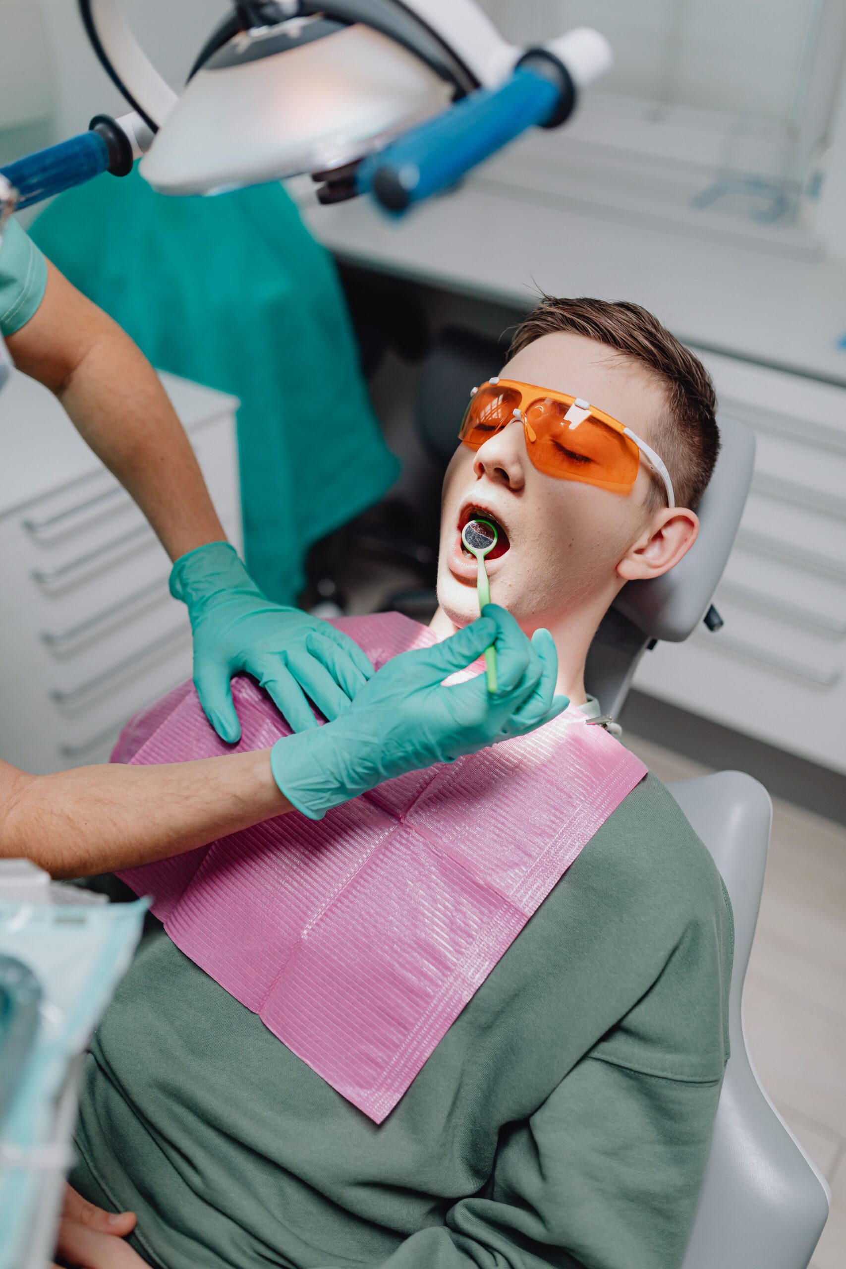 A smiling patient sharing a high five with a dental professional