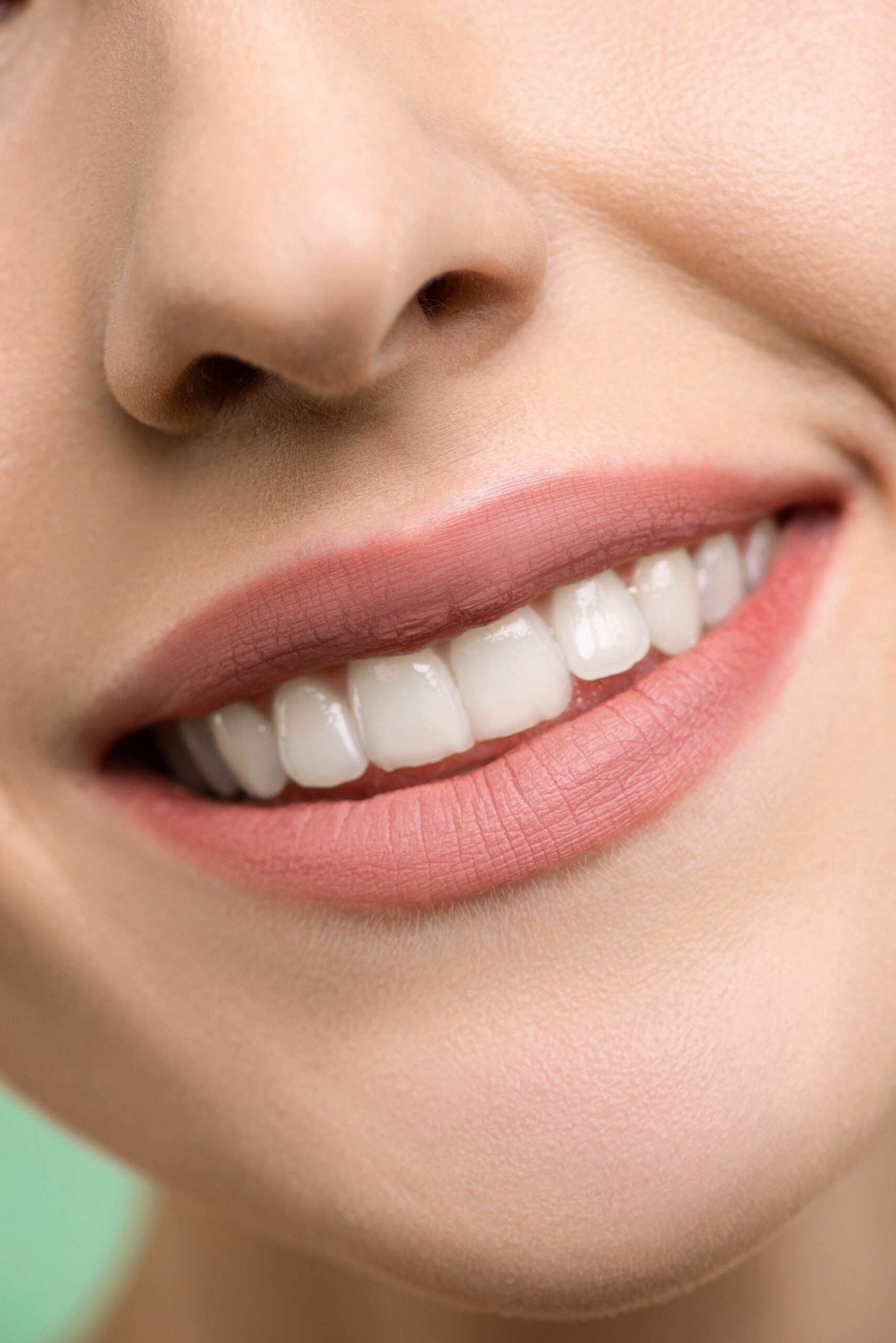 A smiling patient sharing a high five with a dental professional