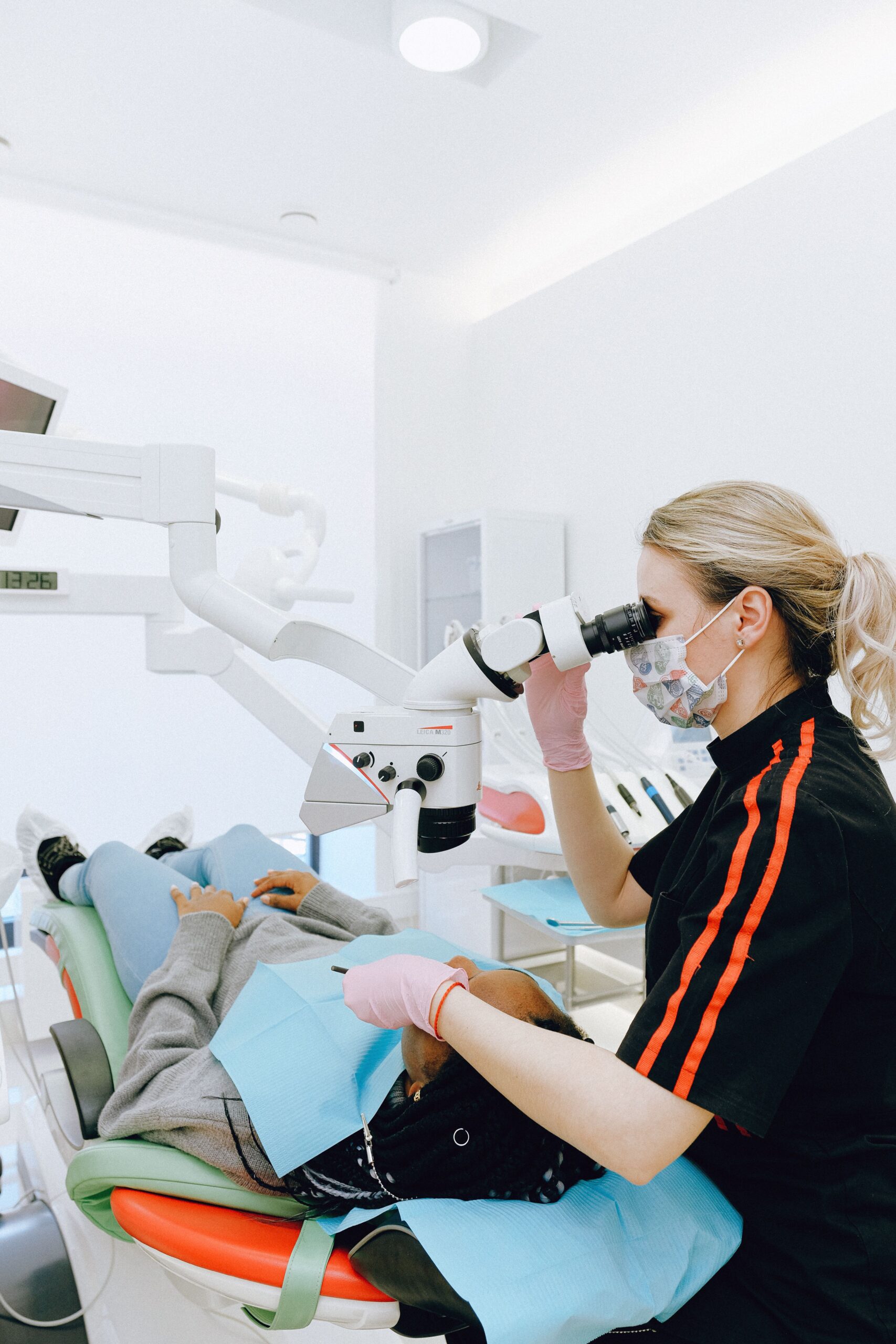 A smiling patient sharing a high five with a dental professional
