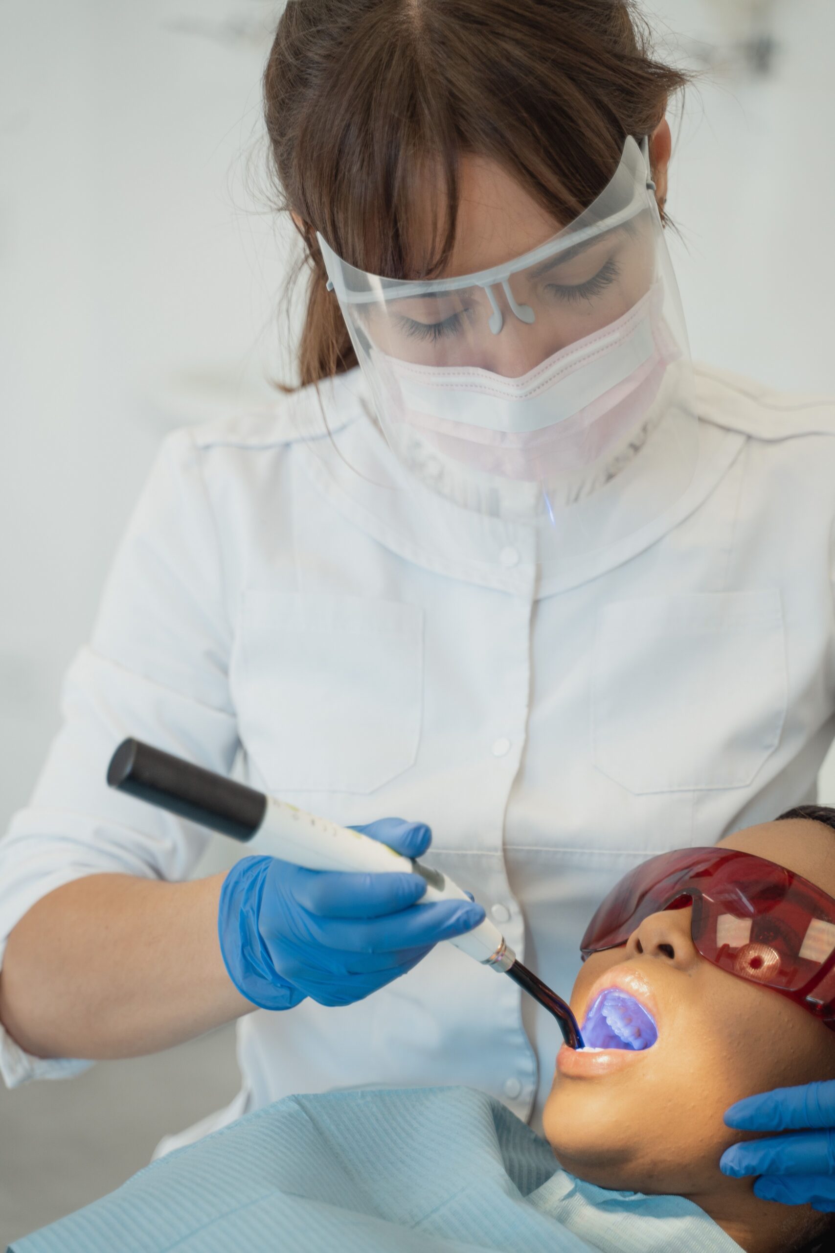 A dental professional discussing a tooth shade with a patient