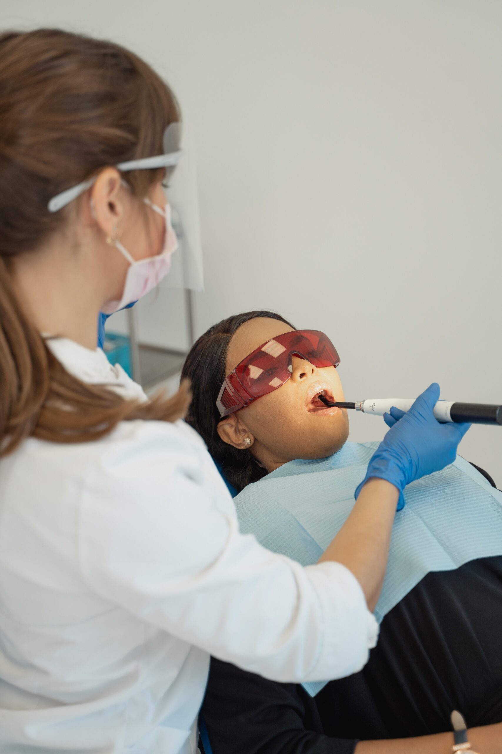 A dental professional discussing a tooth shade with a patient