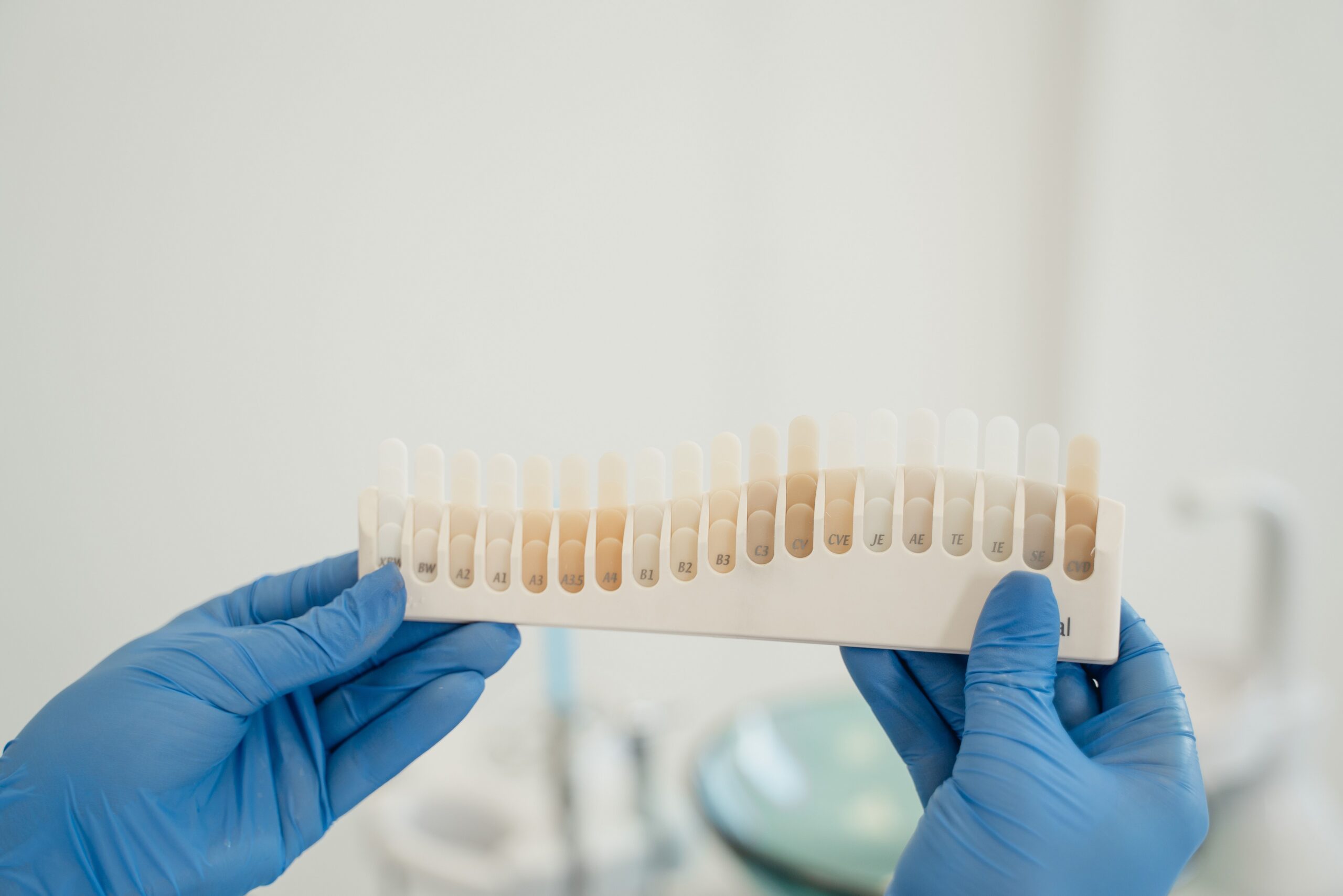 A dental professional discussing a tooth shade with a patient