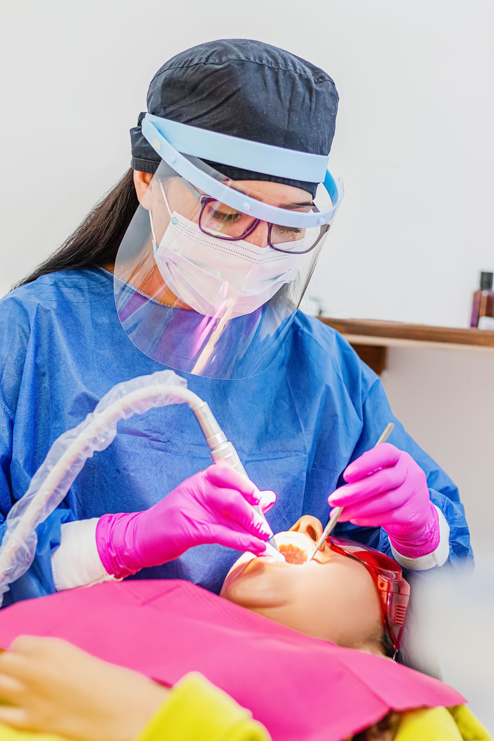 A smiling patient sharing a high five with a dental professional