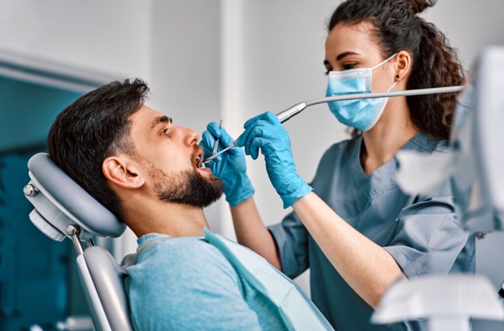 A dental patient having their teeth cleaned during a regular appointment as preventative care to help avoid a root canal